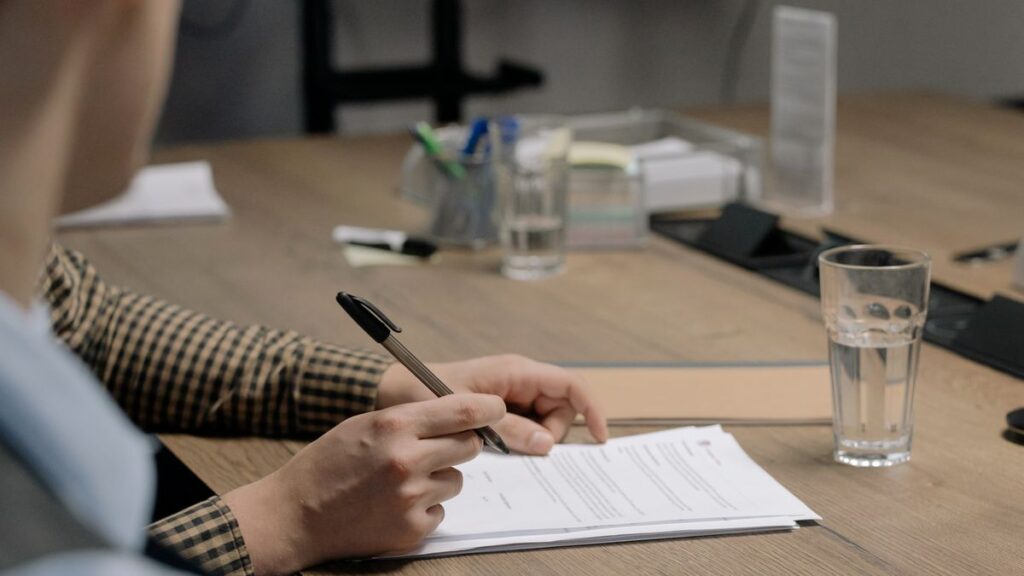 HR manager signing an experience letter format on company letterhead