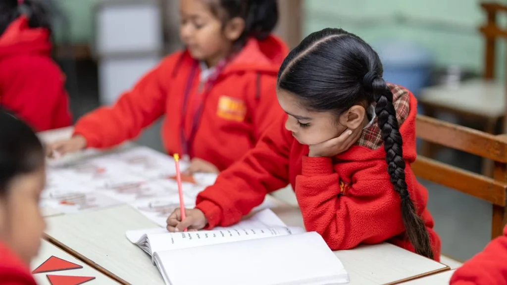Students practising formal letter writing at their school desks